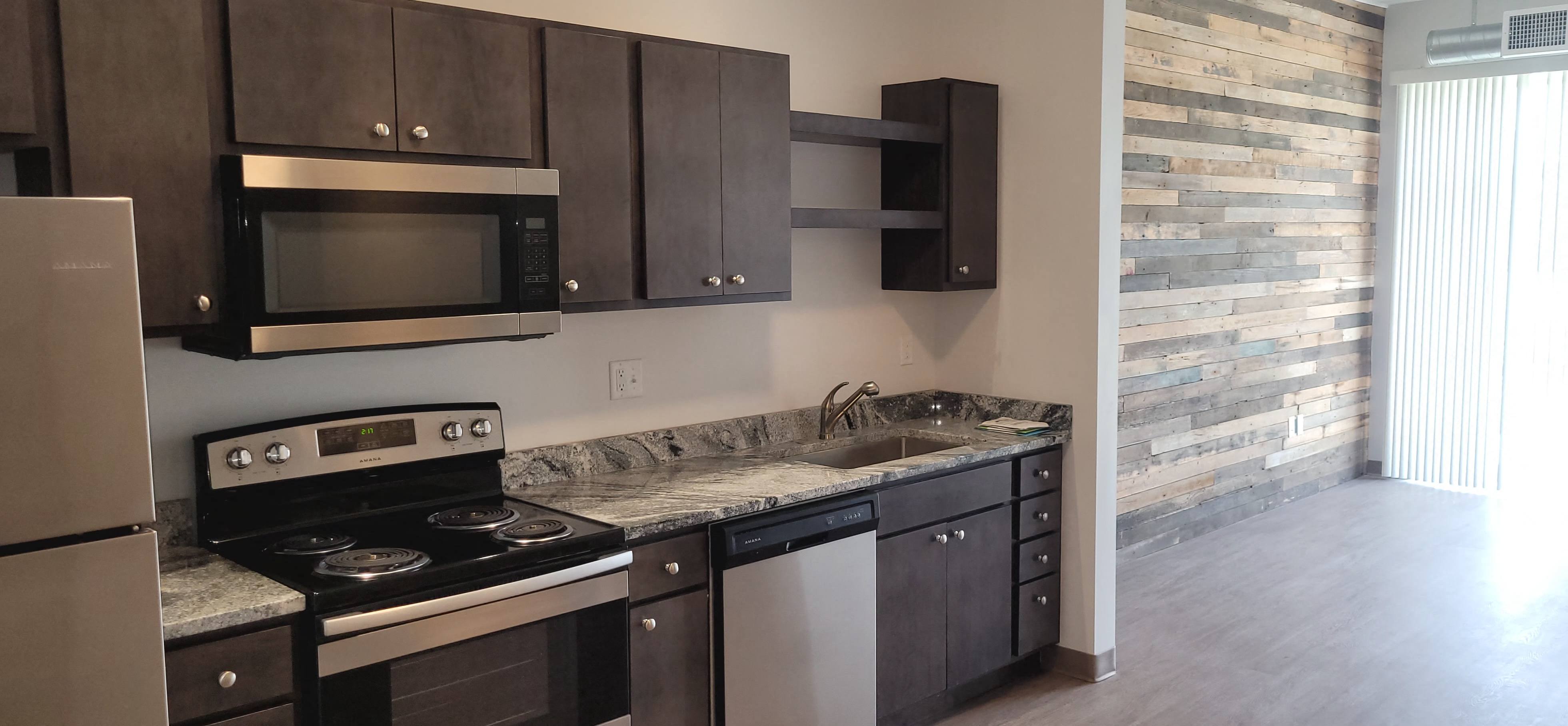 a kitchen with a sink and a stove and a microwave